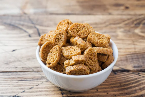 stock image Croutons of grain bread with spices in the dishes. Wooden background