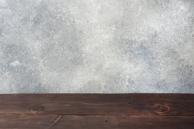 Beton duvar arka plan, Fotoğraf montaj veya ürün görüntü, masaya öğelerini yerleştirmek için boş alan ile ahşap masa.
