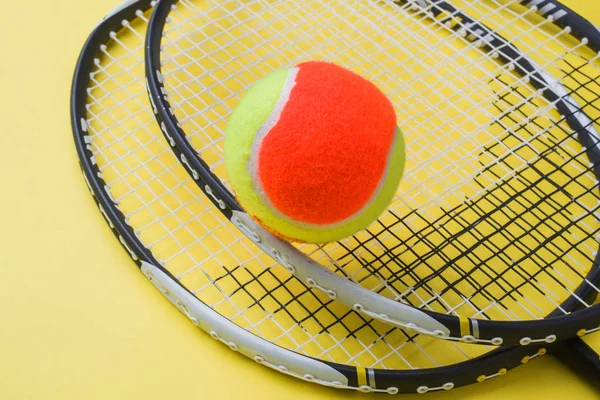 Tennis Ball and rackets on yellow Background, Sport Concept and Idea
