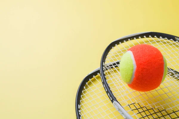 Tennis Ball and rackets on yellow Background, Sport Concept and Idea