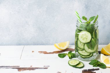 Sağlıklı yaşam için su detoks. Limon, salatalık ve ahşap masa nane kavanozu tatlı suda. Kopya alanı