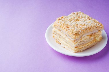 Puf kek krem Napoleon yağlı vanilyalı dilim renk mor zemin üzerine ile.