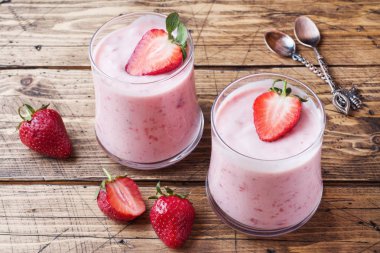 Ahşap bir arka plan üzerinde gözlük taze çilek ile ev yapımı yoğurt. Seçici odak. Kopyalama alanı.