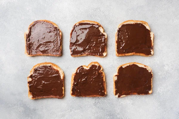 Sandwiches with chocolate paste on the gray table. Top view