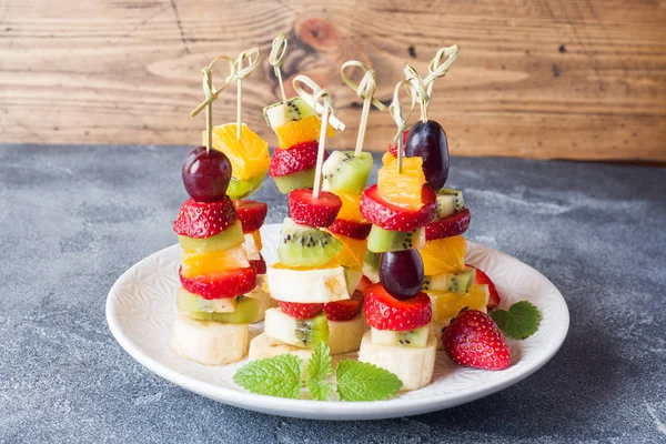 Fruta fresca em espetos. Conceito buffet para uma festa de verão. Espaço de cópia — Fotografia de Stock