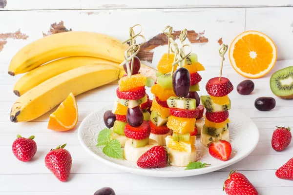 Fresh fruit on skewers. Concept buffet for a summer party.