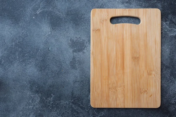 empty wooden cutting board on kitchen table. Top view copy space