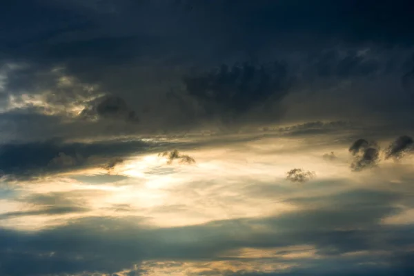 Sunset breaks through the dark clouds. Texture sky Royalty Free Stock Photos