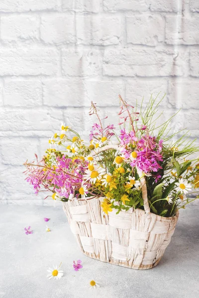 Bouquet of beautiful wildflowers in a basket on a gray background with copy space. — Stock Image Bouquet of beautiful wildflowers in a basket on a gray background with copy space. Royalty Free Stock Images