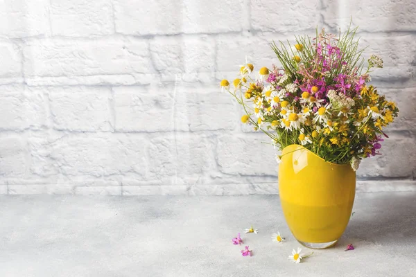 Bouquet of beautiful wildflowers in vase on a gray background with copy space. — Stock Image Bouquet of beautiful wildflowers in vase on a gray background with copy space. Royalty Free Stock Images
