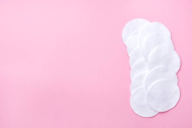 Pembe bir arka plan üzerinde pamuk yuvarlak bezler. Seçici odak Kopyalama alanı.