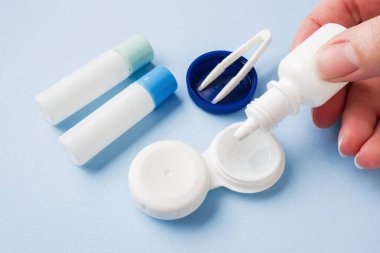 Kontakt lensler, cımbız ve lensler, çözelti ve nemlendirici damlalar için konteynerler depolamak için bir konteyner. Kapat şunu. Seçici odak.