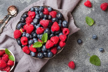 Taze ahududu ve yaban mersini koyu arka plan üzerinde plaka. Kopyalama alanı.