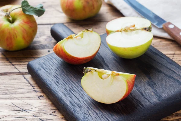 Red apples on a wooden table. Apples cut into slices. Copy space. Stock Image