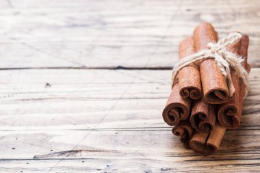 Birkaç tarçın ahşap bir arka plan üzerinde iplik ile bağlı sopalar. Kopya alanı. Seçici odaklama.