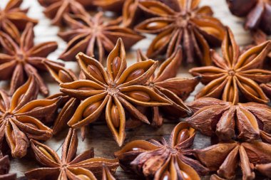 Badian Star anise on a wooden background. Selective focus. clipart