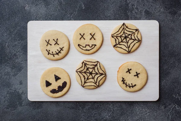 Homemade cookies for Halloween. Cookies with funny faces and spider webs.