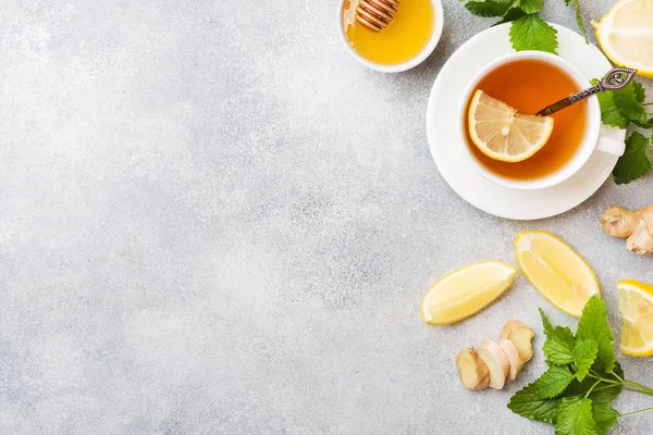 White Cup with natural herbal tea ginger lemon mint and honey. Gray background Copy space. — Stock Photo, Image