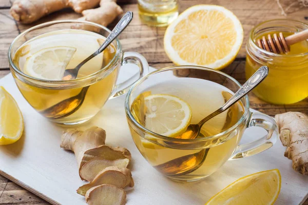 Two cups of natural herbal tea ginger lemon and honey on a wooden background. — Stock Photo, Image