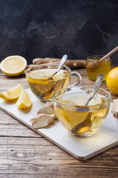 Two cups of natural herbal tea ginger lemon and honey on a wooden background. Copy space — Stock Photo, Image