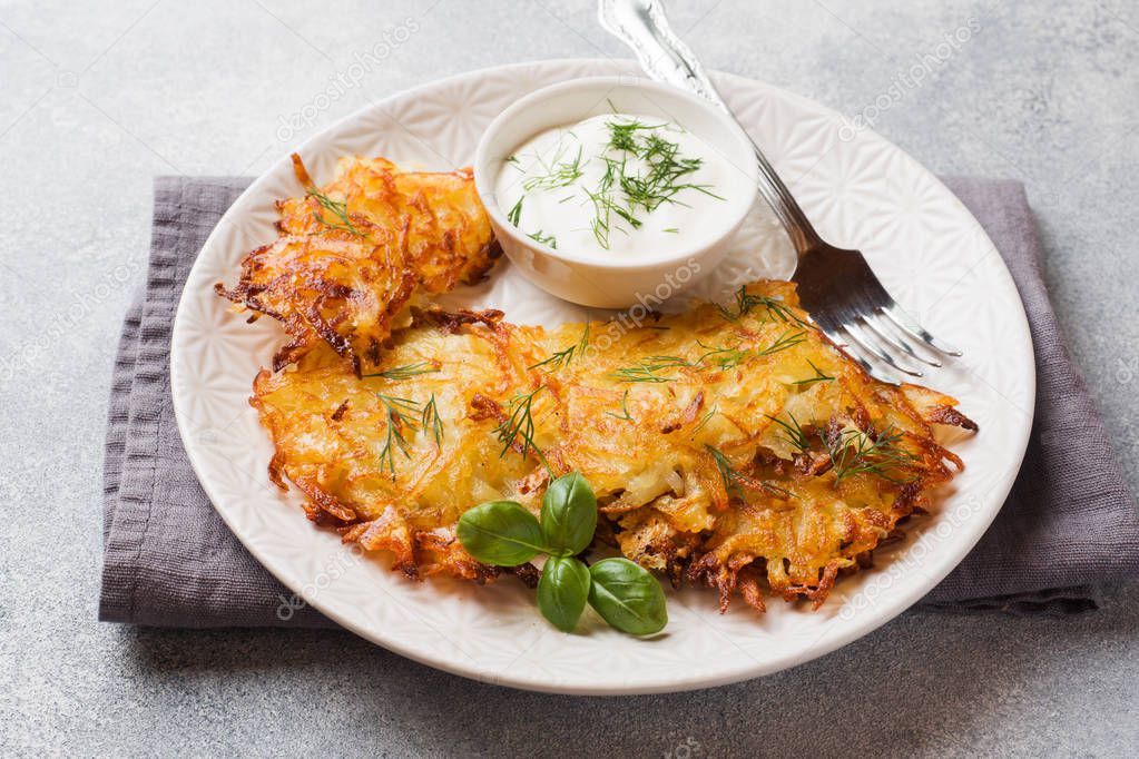 Fried cakes of grated potatoes on the plate with sauce. Traditional pancakes boxty raggmunk