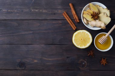 Doğal bitkisel çay zencefil limon ve bal tarçın ile Beyaz Fincan. Enerji vitamini içeceği soğuk algınlığı için kullanılır. Koyu ahşap arka plan kopyalama alanı