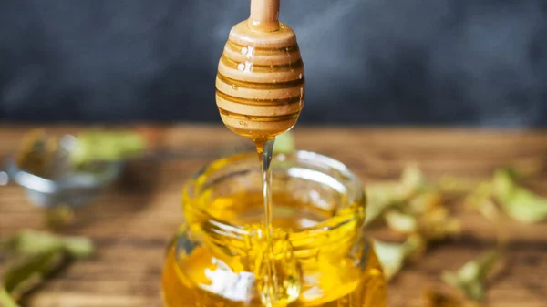 Miel líquida dorada. Miel fresca recogida en la hierba . —  Fotos de Stock
