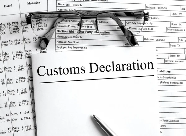 Paper with text Customs Declaration on a financial tables with glasses. Business and financial conzept