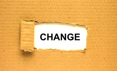 Değişim kelimesi yırtık kahverengi kağıdın arkasında beliriyor. Konsept fotoğraf olarak kullanılabilir.