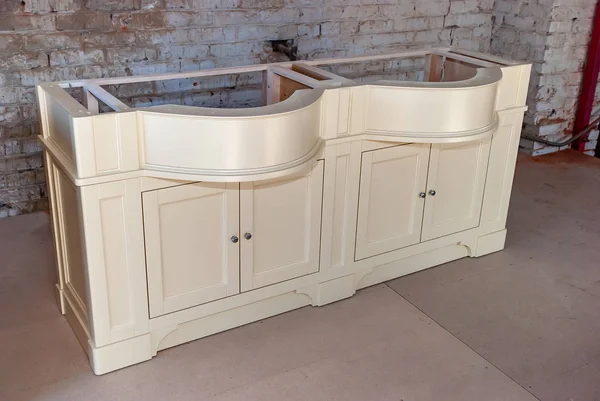 Bathroom vanity cabinet for two washbasins against the old brick wall background