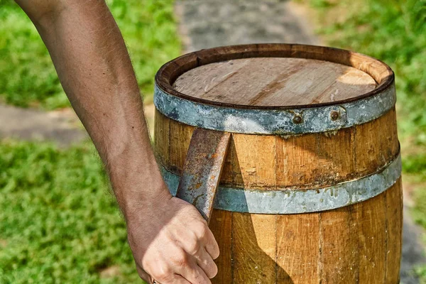 Wooden barrel for 20 liters. Wooden barrel covered with wax. Opening the barrel with a chisel and hammer