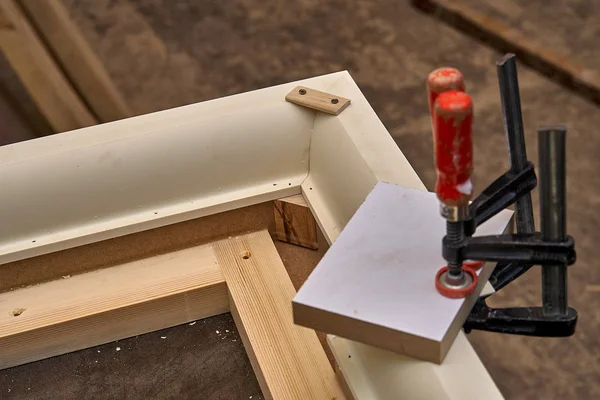 Crown molding. Home library with classic design. Work in progress. Wooden furniture manufacturing process