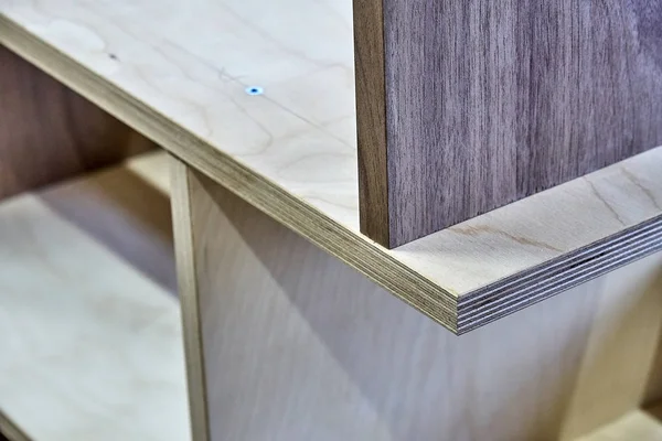 Plywood bookshelves. Production of wood furniture. Furniture manufacture. Close-up