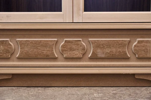 Mdf cabinet carcass with moldings and wooden carved capital. Wooden furniture manufacturing process — Stock Photo, Image