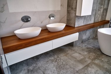 Luxury bathroom vanity. Stylish interior of modern bathroom with teak tabletop and marble walls