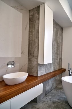 Luxury bathroom vanity. Stylish interior of modern bathroom with teak tabletop and marble walls
