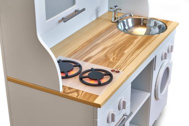 Toy kitchen set. Children white colored and wooden toy kitchen set isolated on white background