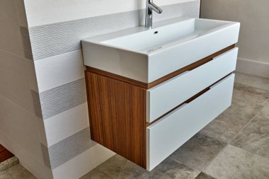 Wall mounted bathroom vanity in luxury bathroom. Stylish interior of modern bathroom. Details furniture