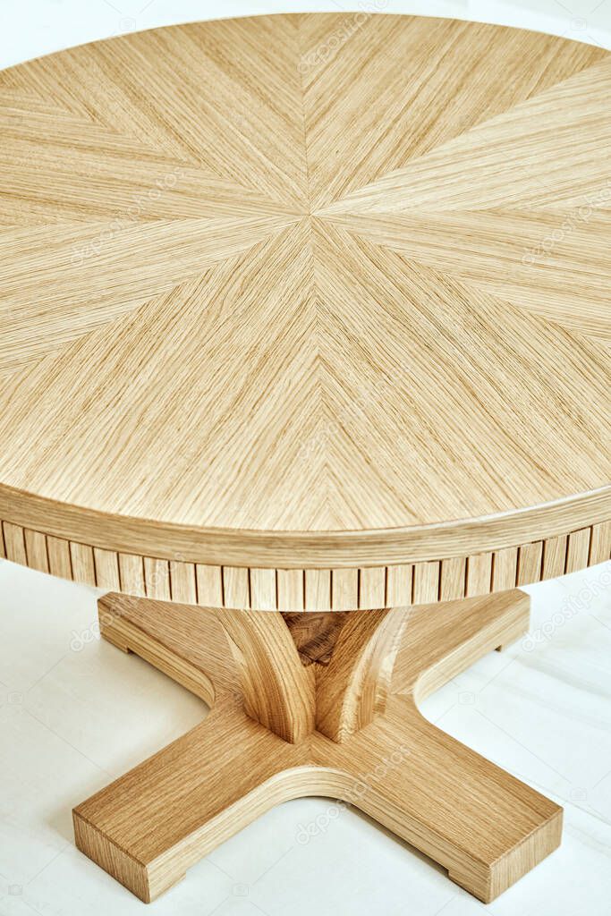 Round shaped wooden table close-up. High angle view. Modern furniture