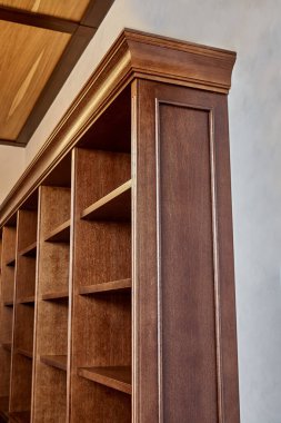 Ev kütüphanesi. Evdeki kütüphaneye yerleştirilmiş boş rafları olan antik ahşap kitaplığın ayrıntıları