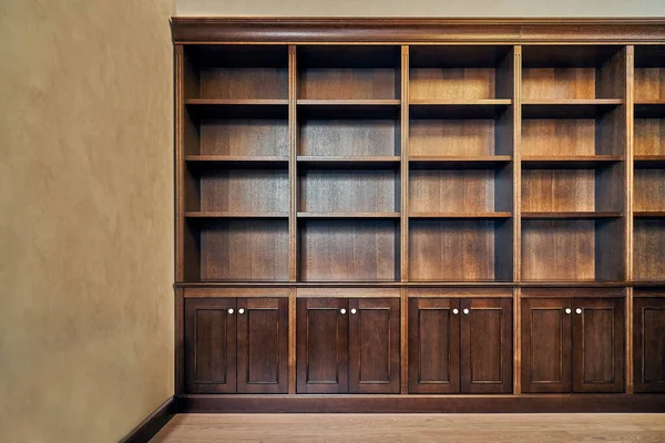 Home library. Detail of antique wooden bookcase with empty shelves placed in home library in house