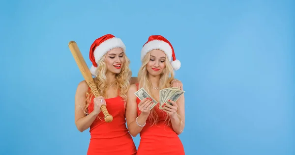 Girls dressed in santas count money after robbing a bank.