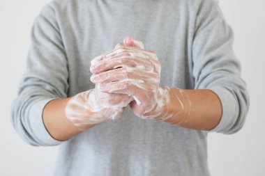 Erkek, COVID-19 Corona virüs önleme konsepti için sabunla ellerini yıkıyor.