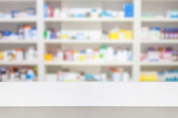 pharmacy counter with blur shelves of drug in the pharmacy drugstore background