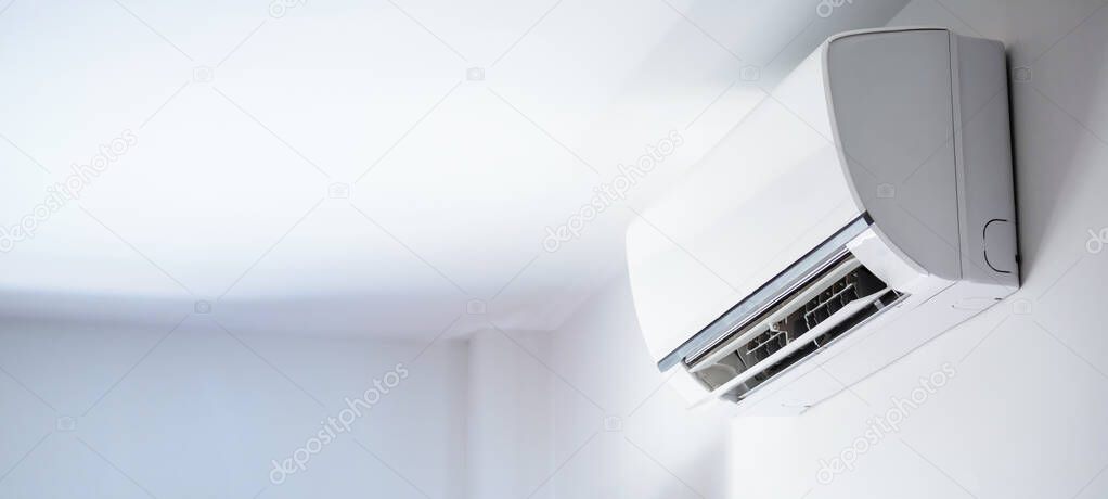 Air conditioner on white wall room interior background