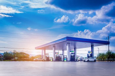 Gas fuel station with clouds and blue sky clipart