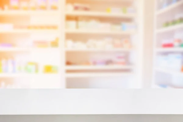 pharmacy counter with shelves filled with medication blur background