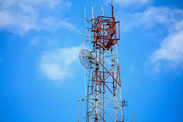 Telecommunication tower and satellite antennas wireless technology on blue sky