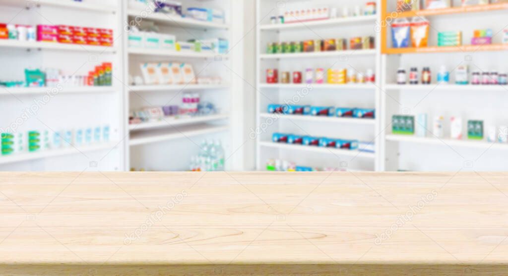 Pharmacy drugstore counter table with blur abstract backbround with medicine and healthcare product on shelves