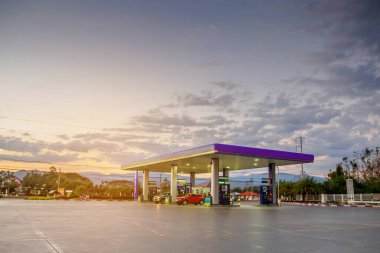 gas station with clouds and sky at sunset clipart